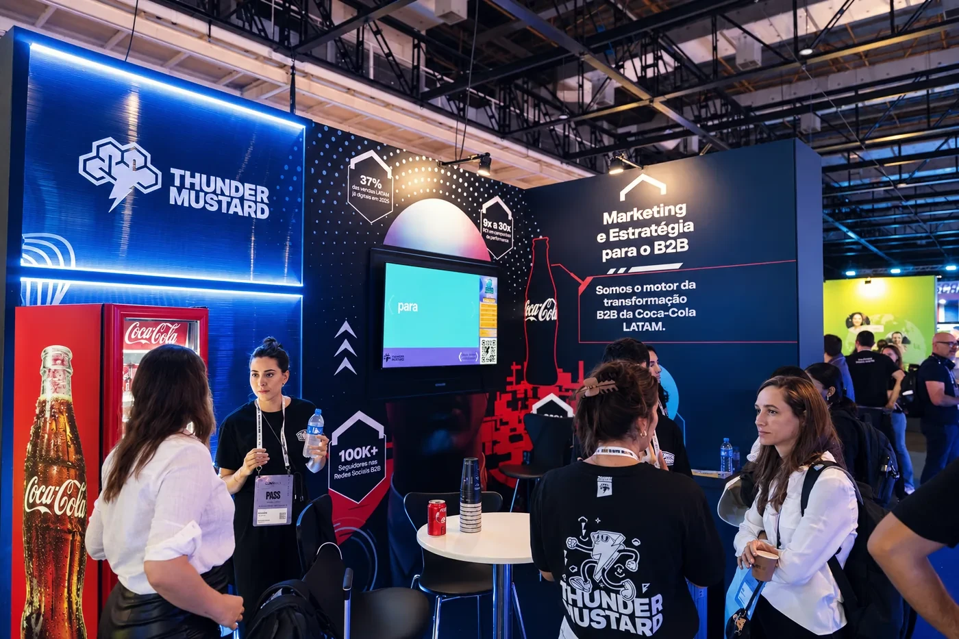 The Thunder Mustard team talking with visitors at its B2B marketing and strategy booth.